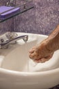 Soaping hands in bathroom sink Royalty Free Stock Photo