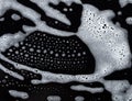 Soapy foam texture on black Royalty Free Stock Photo