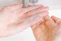 Soapy hands on the background of the sink. Royalty Free Stock Photo