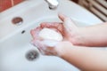 Soapy hands holding soap for hand washing Royalty Free Stock Photo