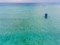 Drone photo of traditional fishermen boats in the blue and clear waters of Pulau Tabuhan, Banyuwangi, Indonesia Royalty Free Stock Photo