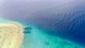 Drone photo of traditional fishermen boats in the blue and clear waters of Pulau Tabuhan, Banyuwangi, Indonesia Royalty Free Stock Photo