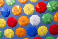 Soaring colored umbrellas against a blue sky