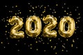 Soaring Numbers 2020 made from foil balloons on black space and sparkles. Christmas and new year concept Royalty Free Stock Photo