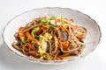 Soba noodles with beef, carrots, onions and sweet peppers isolated on white background Royalty Free Stock Photo