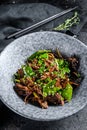 Soba noodles with beef, carrots, onions and sweet peppers. Stir fry wok. Black background. Top view Royalty Free Stock Photo