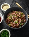 Soba noodles, buckwheat on a black bowl, with spring onion and sesame seeds. Traditional Japanese food. Royalty Free Stock Photo