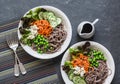 Soba noodles buddha bowl. Buckwheat noodles with vegetables on a dark background, top view.