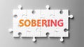 Sobering complex like a puzzle - pictured as word Sobering on a puzzle pieces to show that Sobering can be difficult and needs Royalty Free Stock Photo