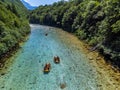 Soca Valley, Slovenia - Aerial view of the emerald alpine river Soca with rafting boats going down the river Royalty Free Stock Photo