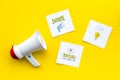 Socail media announcements concept. Megaphone near social media icons on yellow background top view