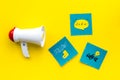 Socail media announcements concept. Megaphone near social media icons on yellow background top view