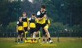 Soccer Academy For Teenagers. Youth Football Player in Strength and Agility Training. Young Boys in the Football Team At Workout