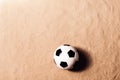 Soccer ball against sandy beach. Studio shot. Copy space.