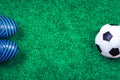 Soccer ball and cleats against green artificial turf Royalty Free Stock Photo