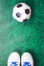 Soccer ball and cleats against green artificial turf Royalty Free Stock Photo
