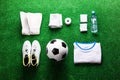 Soccer ball,cleats and various football stuff against artificial Royalty Free Stock Photo