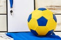 Soccer ball, clipboard, whistle, uniform