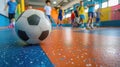 Soccer ball on a colorful indoor court with kids playing in the background.