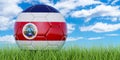 Soccer ball with Costa Rican flag on the green grass against blue sky, 3D rendering Royalty Free Stock Photo