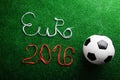 Soccer ball and Euro 2016 sign against artificial turf