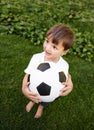 Soccer, ball and excited child in garden for game, playing and fun on grass at home. Smile, happiness and boy with Royalty Free Stock Photo