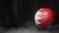 Soccer ball in flag colors on a dark abstract background. Bahrain.