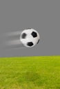 Soccer ball flying over a soccer field Royalty Free Stock Photo