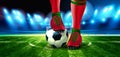 Soccer ball on Football Arena with a part of the foot of a football player. Royalty Free Stock Photo