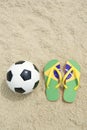 Soccer Ball Football and Flip-Flops on Brazilian Beach
