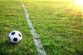 A soccer ball or football in stadium with sunset