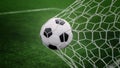 Soccer ball on goal with net and green background Royalty Free Stock Photo