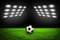 Soccer ball on grass against black background Royalty Free Stock Photo