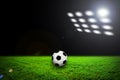 Soccer ball on grass against black background Royalty Free Stock Photo