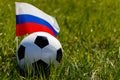 Soccer ball on the grass and the Russian flag. There is a place for the inscription