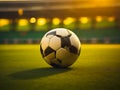 Soccer ball on the grass of a soccer field in golden sunset light. generative AI Royalty Free Stock Photo