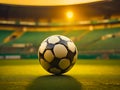 Soccer ball on the grass of a soccer field in golden sunset light. generative AI Royalty Free Stock Photo