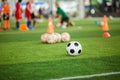 Soccer ball on green artificial turf with blurry soccer team training Royalty Free Stock Photo