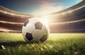 Soccer ball on the green grass of the football arena in golden sunset light. Selective focus with copy space background Royalty Free Stock Photo