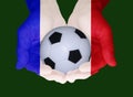 Soccer ball in the hands of the colors of the national flag of France Royalty Free Stock Photo
