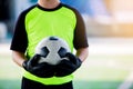 Soccer ball in hands of goalkeeper. Soccer player training