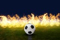 Soccer ball on the lawn of the stadium with fire effect