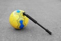 Soccer ball with manual pump inflator on asphalt