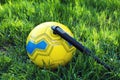 Soccer ball with manual pump inflator on green grass