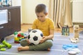 Soccer ball in a medical mask. Activities at home with your children during home coronavirus quarantine