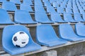 Soccer ball in a medical mask on the background of empty stands . Royalty Free Stock Photo