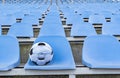 Soccer ball in a medical mask on the background of empty stands . Royalty Free Stock Photo