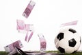 Soccer ball near flying euro banknotes Royalty Free Stock Photo