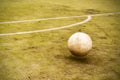 Soccer ball on the old soccer field. Yard football. Close-up