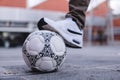 Soccer ball with one foot stopping it. Close up of a black and white soccer ball. White tennis and a white ball. Royalty Free Stock Photo